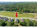A beautiful aerial view of a home with a spacious, tree-lined backyard and neighborhood in a lovely community at 160 Hickory Course Loop, Ocala, FL 34472