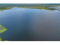Scenic view of the expansive lake, highlighting its natural beauty and tranquility at 23797 Ne 189Th St, Fort Mc Coy, FL 32134