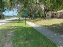 Property featuring mature trees, grassy lawn and Powerhouse Ministry sign at 312 Nw 28Th St, Ocala, FL 34475