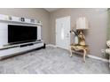 Cozy living room featuring light gray floors in a chevron pattern and ample natural light at 340 Oak Track Loop, Ocala, FL 34472