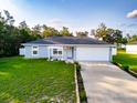 Charming single-story home featuring well-manicured lawn, two car garage, and inviting front entrance at 3897 Sw 169Th Lane Rd, Ocala, FL 34473
