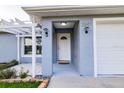 Inviting covered front entrance with sidelight sconces at 3897 Sw 169Th Lane Rd, Ocala, FL 34473