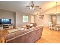 Cozy living room featuring vaulted ceilings, wood floors, and a comfortable seating area at 5410 Nw 62Nd Ave, Ocala, FL 34482