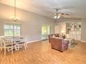 Spacious living room with dining area, vaulted ceilings, and a built-in bookcase providing ample storage at 5410 Nw 62Nd Ave, Ocala, FL 34482