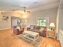 Inviting living room with comfortable seating, wood floors, and natural light creating a cozy atmosphere at 5410 Nw 62Nd Ave, Ocala, FL 34482