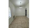 Dining room with tile flooring, chair rail, and modern chandelier fixture at 5525 Se 43Rd Ct, Ocala, FL 34480