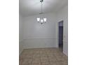 Dining room with tile floors, chair rail, and decorative chandelier at 5525 Se 43Rd Ct, Ocala, FL 34480