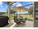 Inviting screened porch featuring comfortable seating and a view of the serene lake and golf course at 5728 Sw 90Th Court Rd, Ocala, FL 34481