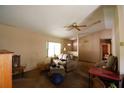 Cozy living room with a ceiling fan, one window providing natural light, and neutral-toned walls, needing your personal touch at 8 Juniper Pass Way, Ocala, FL 34480