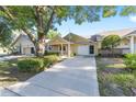 Charming yellow single-story home featuring a covered front porch, one-car garage, and mature landscaping at 8710 Sw 91St Pl # B, Ocala, FL 34481