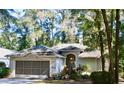 Charming single-story home featuring a well-maintained yard, attached garage, and inviting entrance at 8735 Sw 192Nd Court Rd, Dunnellon, FL 34432