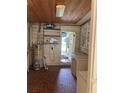 Utility room includes a water heater, sink and mosaic tile floor, with a view out to the front yard at 922 Se 13Th St, Ocala, FL 34471