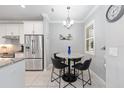 Eat-in kitchen features stainless steel appliances, stone countertops, and a chandelier at 9658 Sw 76Th Lane Rd, Ocala, FL 34481