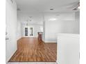 Bright living room with wood floors, recessed lighting, and bar area at 10016 Sw 62Nd Cir, Ocala, FL 34476