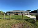 Inviting single-story home featuring a gated front yard and a well-manicured lawn at 1100 Nw 126Th Ln, Citra, FL 32113