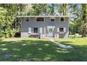 Charming home with fresh exterior paint, white shutters, front yard and blue door at 11170 Sw 190Th Ave, Dunnellon, FL 34432