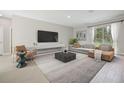 Spacious living room with a large window, comfortable seating, and modern decor at 16094 Sw 42Nd Ter, Ocala, FL 34473