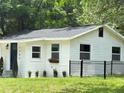 Side view of a well-maintained white home with a dark blue door and freshly cut lawn at 1705 Nw 18Th Ave, Ocala, FL 34475