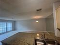 Kitchen island with granite countertops and a view of the open floor plan at 1910 Sw 34Th Ct, Ocala, FL 34474