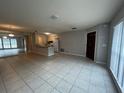 Open-concept living and dining area with neutral tile flooring and lots of natural light at 1910 Sw 34Th Ct, Ocala, FL 34474