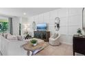 Cozy living room with modern decor, comfortable seating, and natural light at 3066 Canopy Oak Blvd, Wildwood, FL 34785