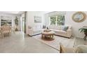 Comfortable living space with neutral walls, tile floors, a sectional sofa, and a modern area rug at 3125 Evenmore Way, Wildwood, FL 34785