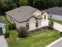 Aerial view showcasing a well-maintained home with a green lawn and a charming landscape at 6235 Sw 95Th Pl, Ocala, FL 34476