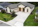 Aerial view of a lovely home highlighting the large driveway and manicured landscaping at 6235 Sw 95Th Pl, Ocala, FL 34476