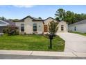 Charming one-story home featuring lush landscaping and a welcoming front yard at 6235 Sw 95Th Pl, Ocala, FL 34476