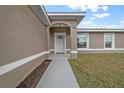 Inviting front entrance featuring a covered porch and manicured landscaping at 7 Walnut Pl, Ocala, FL 34480