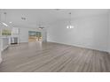 Expansive living area with sleek flooring, modern lighting, and sliding glass doors at 7 Walnut Pl, Ocala, FL 34480