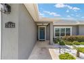 Inviting front entrance with a blue door and well-kept landscaping at 7442 Sw 129Th Ln, Ocala, FL 34473