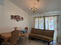 Cozy dining room featuring a chandelier, decorative wall art, and a comfortable sofa at 7800 Sw 127Th Loop, Ocala, FL 34473
