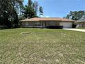 Charming single-story home with a spacious front yard and a two-car garage at 7800 Sw 127Th Loop, Ocala, FL 34473