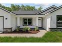 Nice exterior view of the front entrance with tidy landscaping at 8293 Se 158Th St, Summerfield, FL 34491