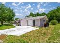Single Gathering home with attached garage and driveway, surrounded by mature trees and blue skies at 9021 Sw 108Th Pl, Ocala, FL 34481