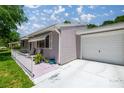 Home with a one-car garage and a cozy, fenced patio area, ideal for outdoor dining at 9021 Sw 108Th Pl, Ocala, FL 34481