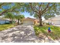Inviting home featuring a spacious driveway and mature trees offering ample shade at 9266 Sw 91St Cir, Ocala, FL 34481
