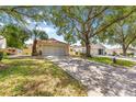 Attractive home with well-manicured lawn and mature trees lining the driveway at 9266 Sw 91St Cir, Ocala, FL 34481