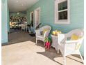 Relaxing front porch featuring wicker furniture, decorative pillows, and a welcoming ambiance at 9330 Se 106Th Pl, Belleview, FL 34420