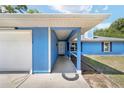 Covered home entrance and front door next to the garage and driveway at 11 Se Fir Trail Trak, Ocala, FL 34472