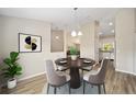 Cozy dining area featuring a round wood table, seating for four, and stylish decor at 1143 Sw Tamiami Pl, Dunnellon, FL 34431