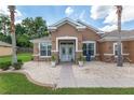 Beautiful single-story home with a manicured lawn, stone accents, and a walkway to the front door at 12804 Se 90Th Court Rd, Summerfield, FL 34491