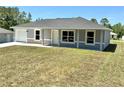 Charming single-story home featuring a well-maintained lawn and an attached one car garage at 14437 Sw 21St Pl, Ocala, FL 34481