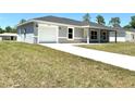 Charming single-story home featuring a well-maintained lawn and an attached one car garage at 14437 Sw 21St Pl, Ocala, FL 34481