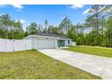 Well-maintained, light-blue home featuring a spacious driveway and partial fencing at 15368 Sw 30Th St, Ocala, FL 34481