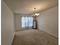 Simple dining room featuring a carpeted floor and hanging chandelier at 18 Fir Trail Dr, Ocala, FL 34472