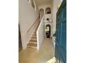 Bright foyer with staircase, featuring neutral tones and a view into the living spaces at 18 Fir Trail Dr, Ocala, FL 34472