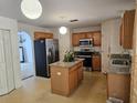 Kitchen with granite countertops, stainless steel appliances, and an island at 18 Fir Trail Dr, Ocala, FL 34472