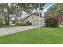 Inviting single-story home featuring a well-manicured lawn and lush bougainvillea at 2008 Tweed Ct, Leesburg, FL 34788
